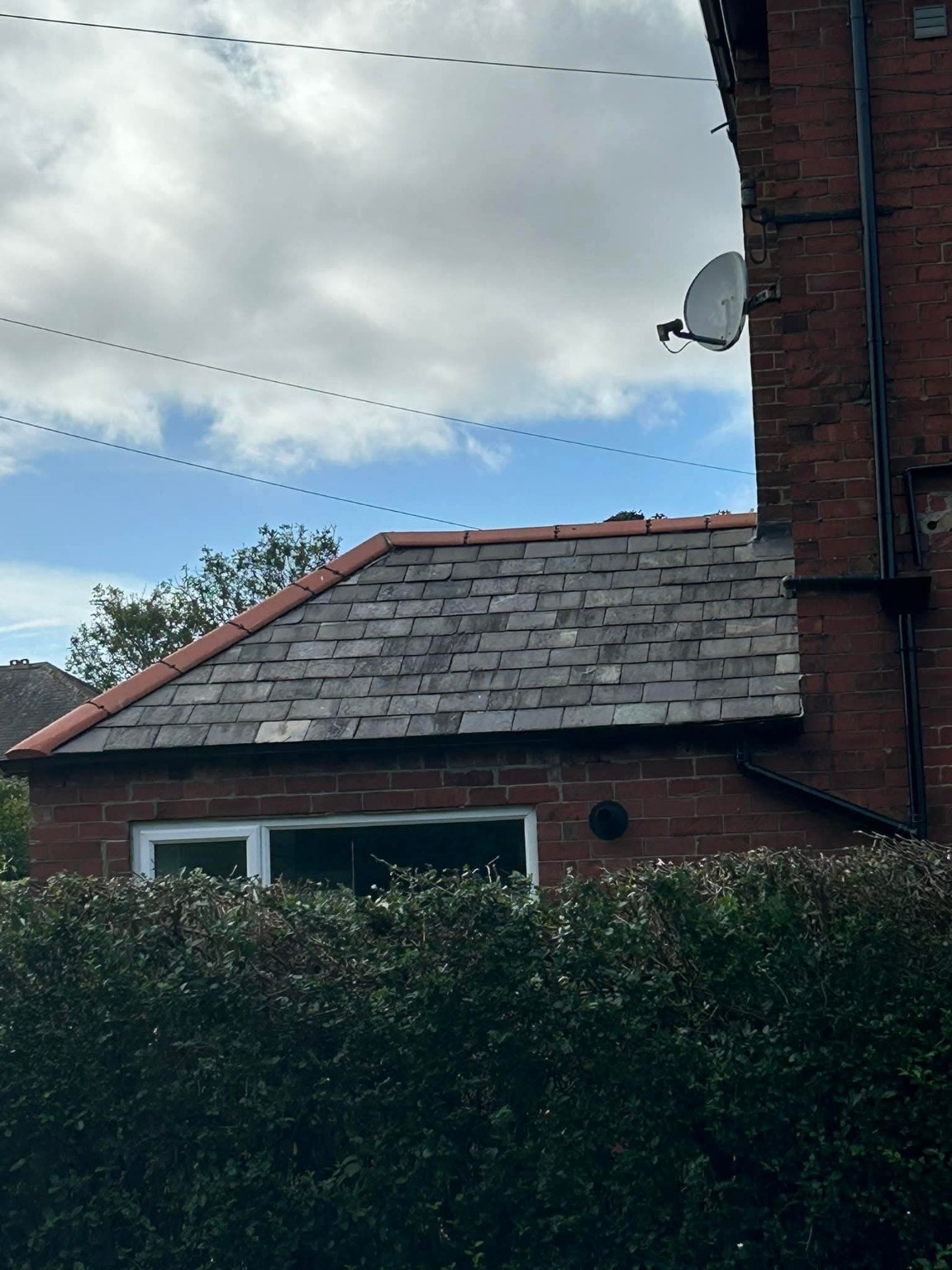 Small slate roof with red ridge tiles