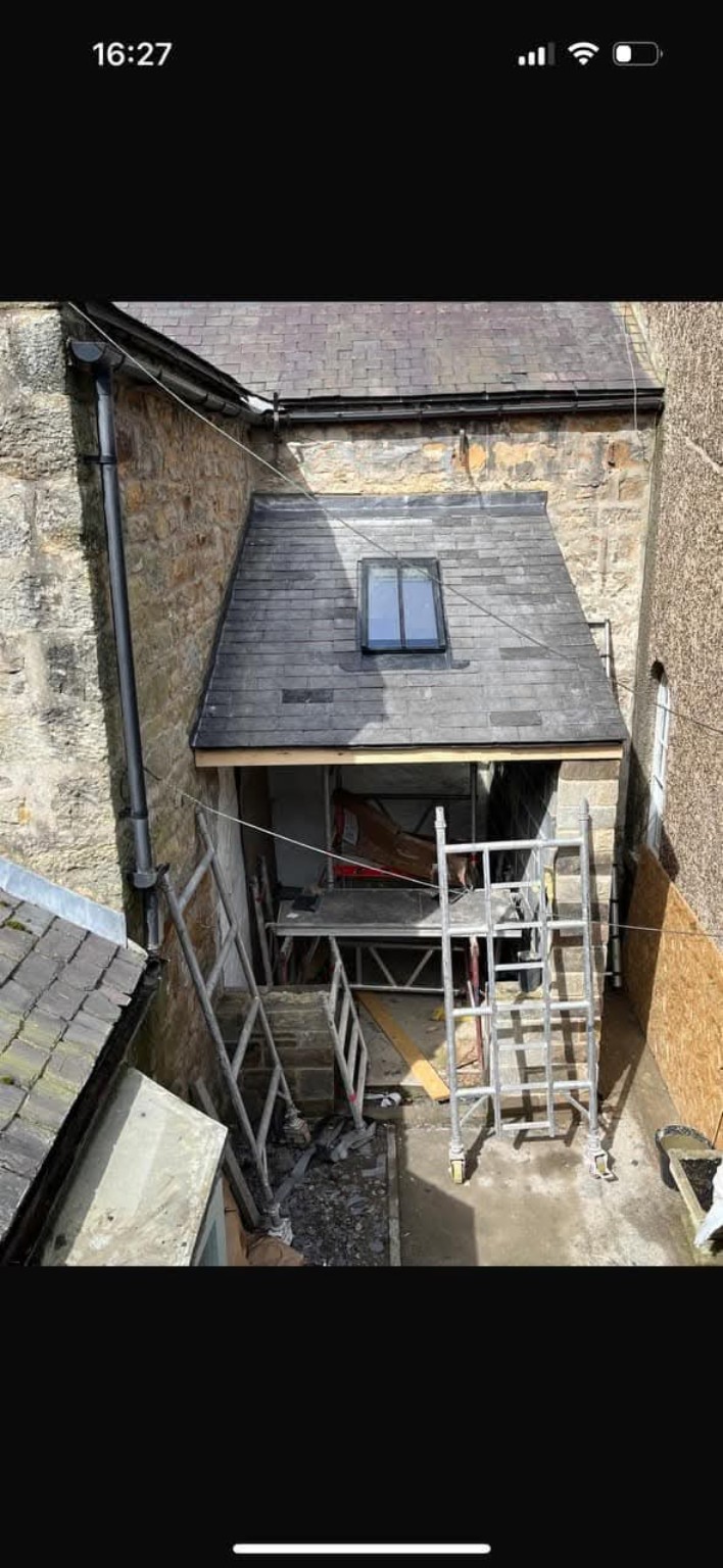 Small slate roof with skylight and access scaffold
